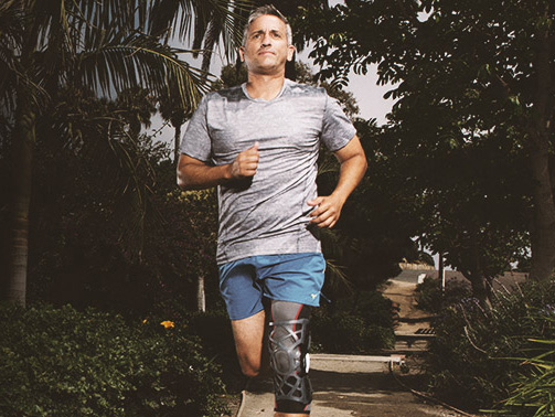 Man jogging with knee brace
